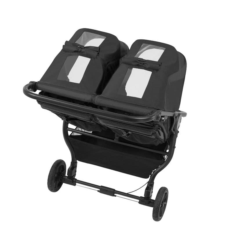 Baby Jogger City Mini GT2 Double stroller in black on a city sidewalk with two children seated
