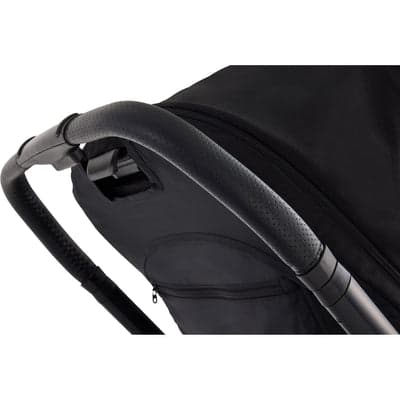 Baby Jogger City Sights stroller in Rich Black on a city sidewalk with reversible seat in parent-facing position