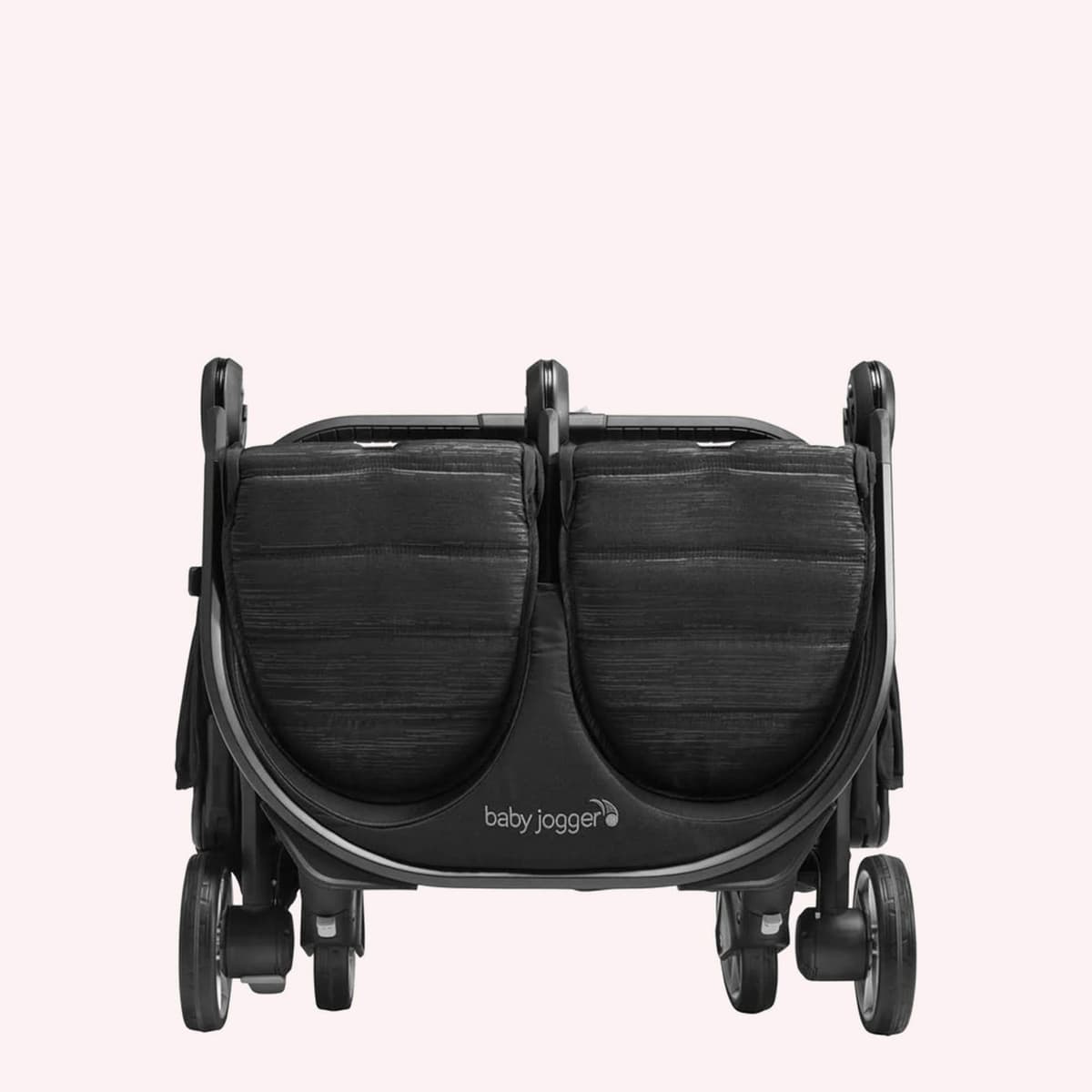 Baby Jogger City Tour 2 stroller in graphite color with included carry bag on a city street