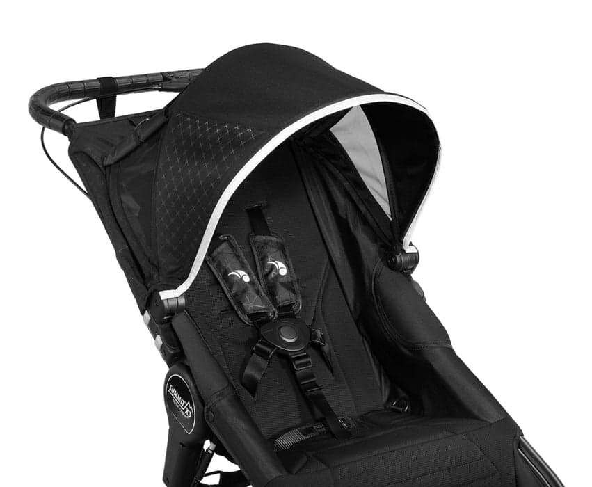 Baby Jogger Summit X3 jogging stroller in black with pneumatic tires on a paved running path