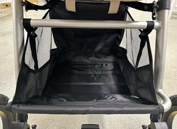 Bumbleride Indie stroller in sea glass color with air-filled tires on a forest trail path