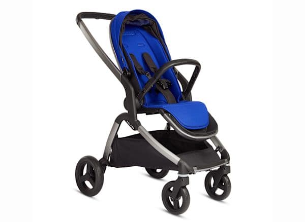 Colugo Complete stroller in sage green with minimalist design on a city sidewalk