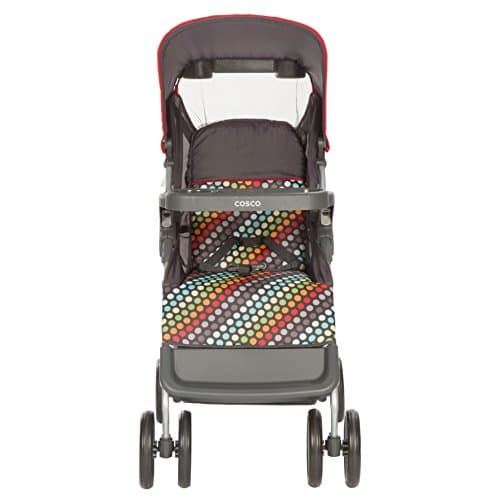 Cosco Lift & Stroll stroller in black on a city sidewalk, compact lightweight design