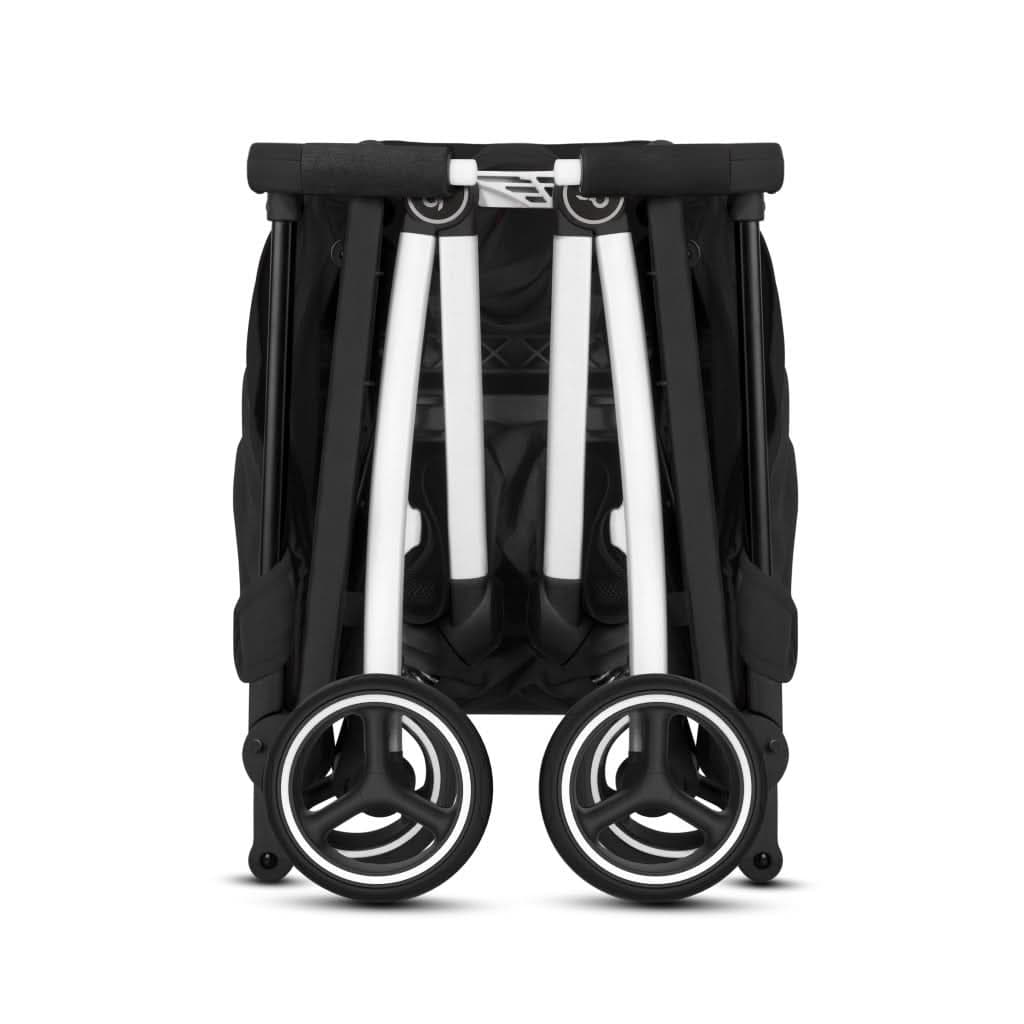 GB Pockit+ All-Terrain stroller folded to backpack size next to a carry-on luggage
