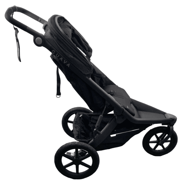 Guava Roam Crossover stroller in slate gray with parent running on a paved trail through a park