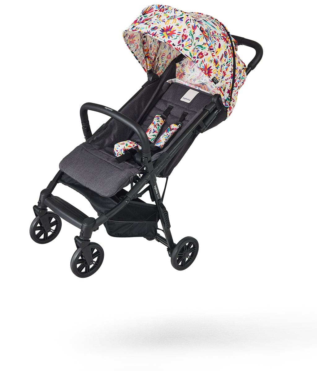 Inglesina Quid 2 stroller in night blue with fully reclined seat on a European city street