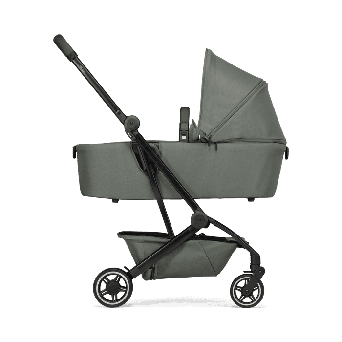 Joolz Aer+ stroller in stone grey folded with travel pouch at airport overhead bin