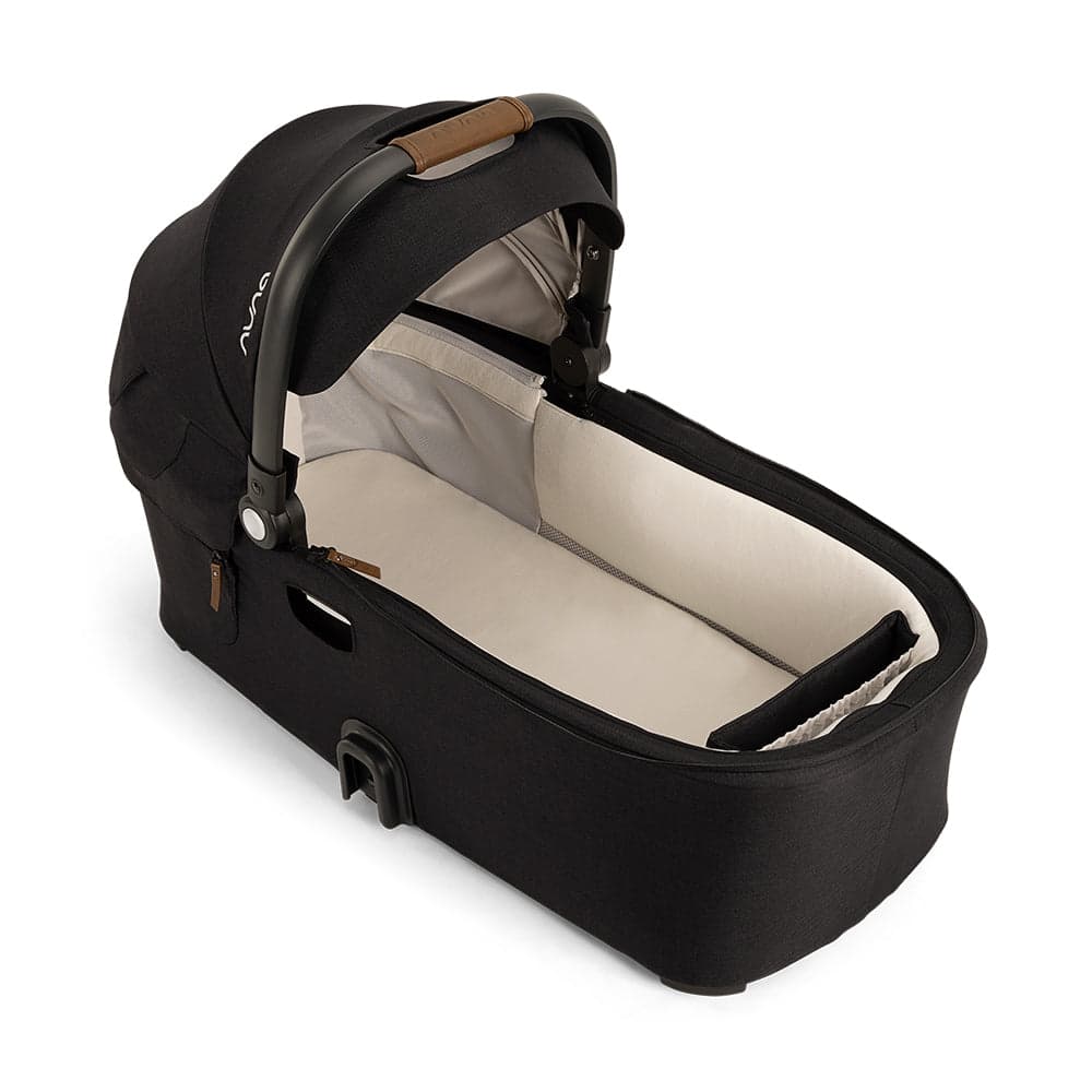 Nuna DEMI Next convertible double stroller in slate with tandem configuration on a city street