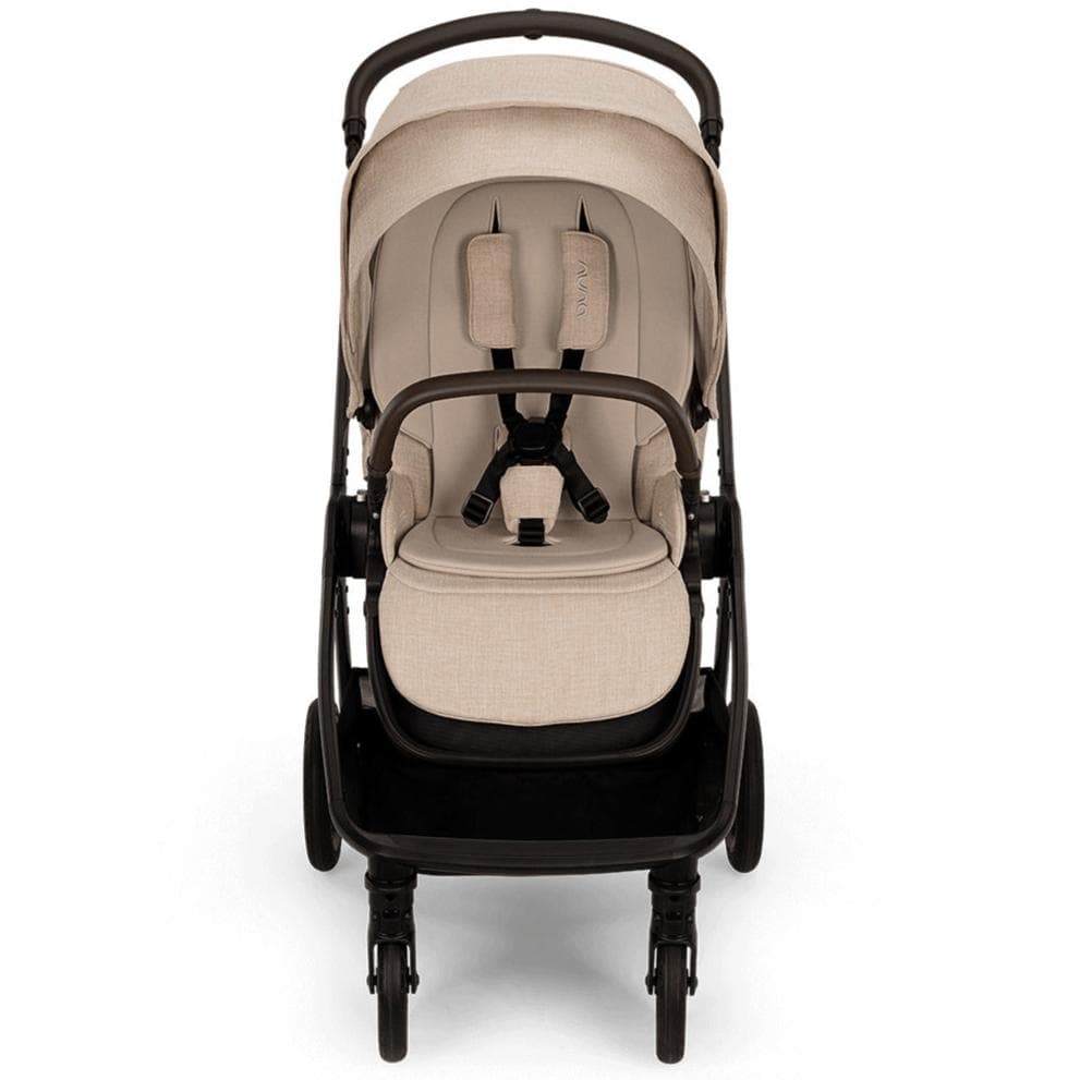 Nuna TRIV Next stroller in caviar black with the seat parent-facing on a city sidewalk