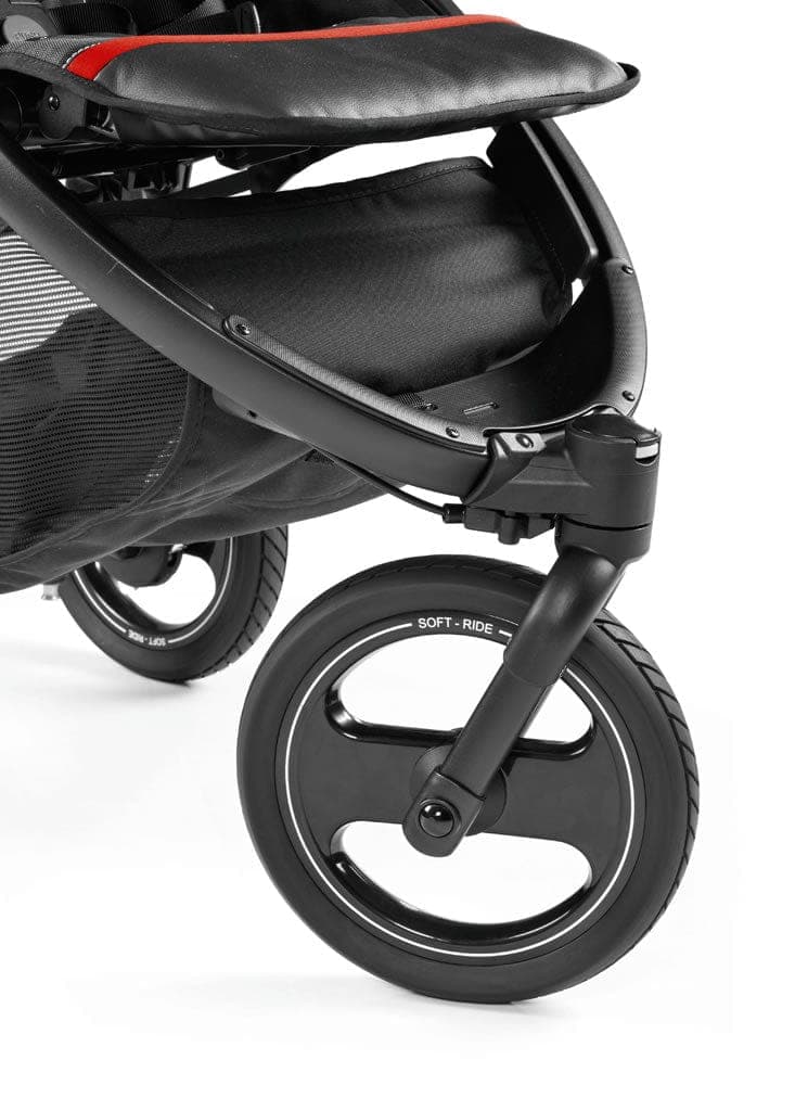 Peg Perego Book Cross stroller in sand beige with air-filled wheels on a gravel park path