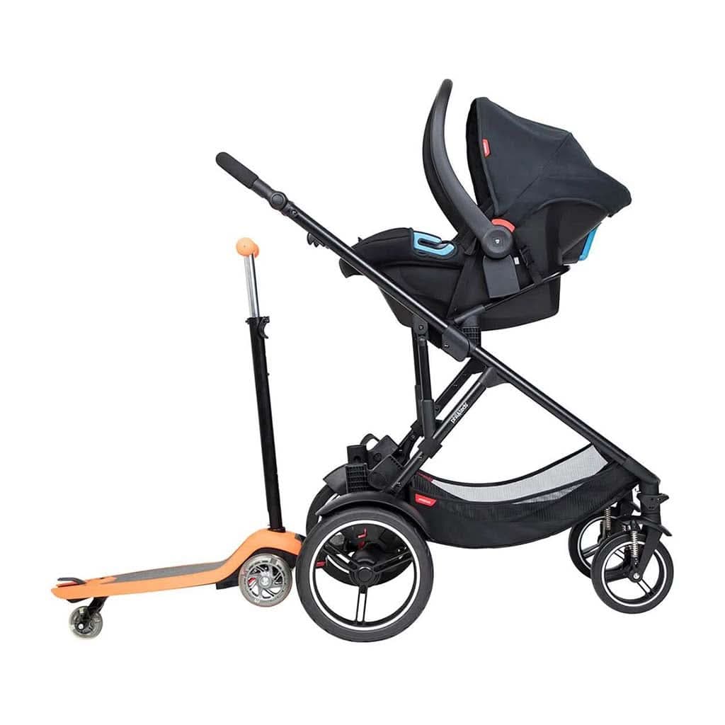 phil&teds Voyager inline double stroller in black with lie-flat main seat and double kit on an urban trail