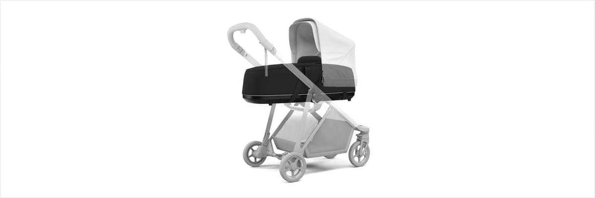 Thule Shine stroller in midnight black with adjustable handlebar raised and parent-facing seat in a Scandinavian urban setting