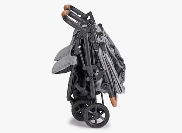 Zoe Twin+ lightweight side-by-side double stroller in slate color folded compactly at an airport gate