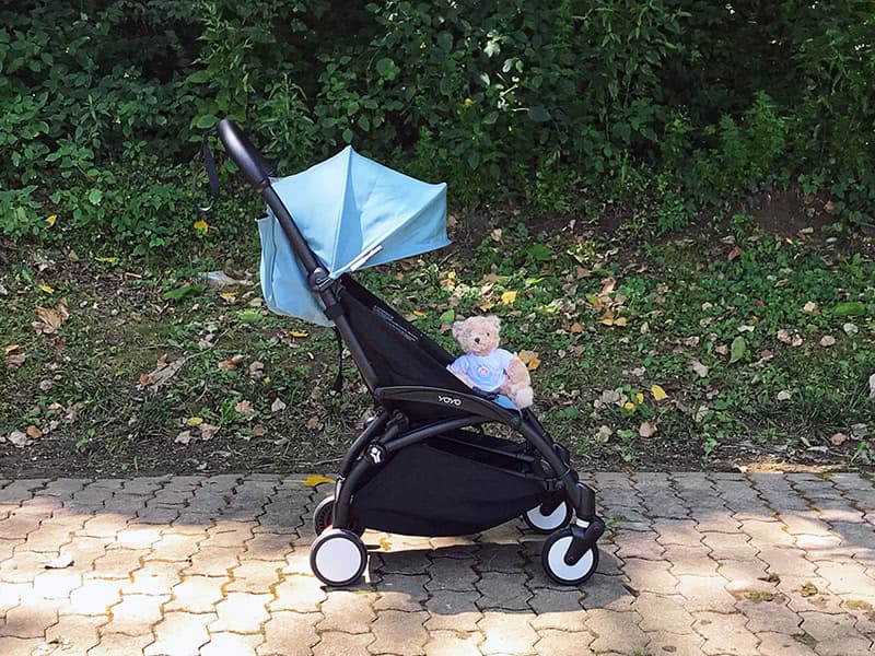 Babyzen YOYO2 stroller in white frame with black color pack folded at airplane gate