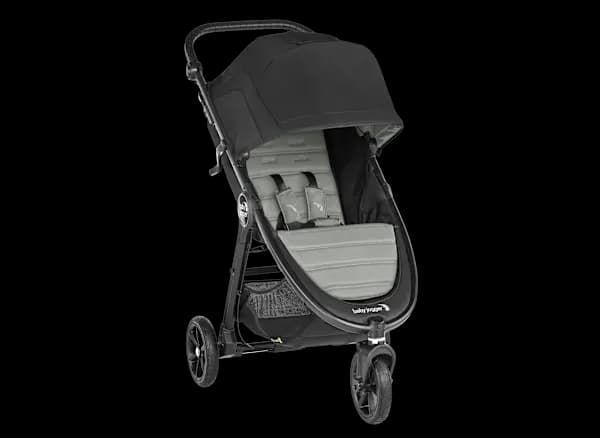 Baby Jogger City Mini GT2 stroller in black on a city sidewalk with all-terrain wheels