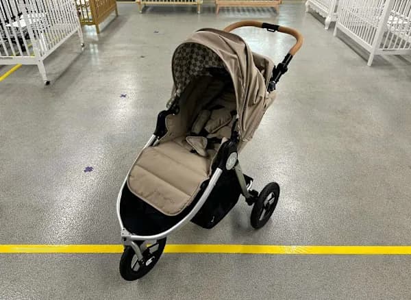 Bumbleride Indie stroller in sea glass color with air-filled tires on a forest trail path
