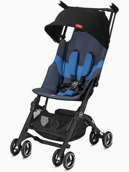 GB Pockit+ All-Terrain stroller folded to backpack size next to a carry-on luggage