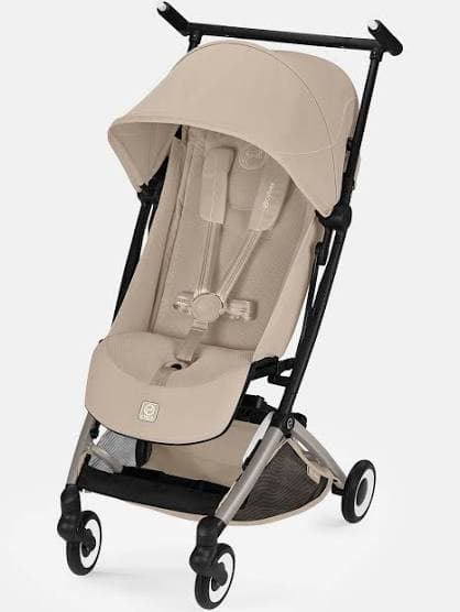 Cybex Libelle stroller folded to ultra-compact size next to an overhead airplane bin