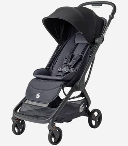 Ergobaby Metro 3 compact stroller in Onyx Black folded upright at an airport gate