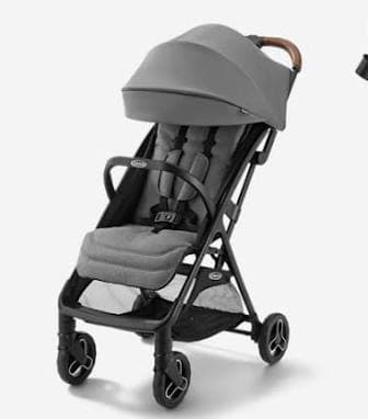 Graco Ready2Jet compact travel stroller in Kingston grey, shown folded beside an airplane overhead bin