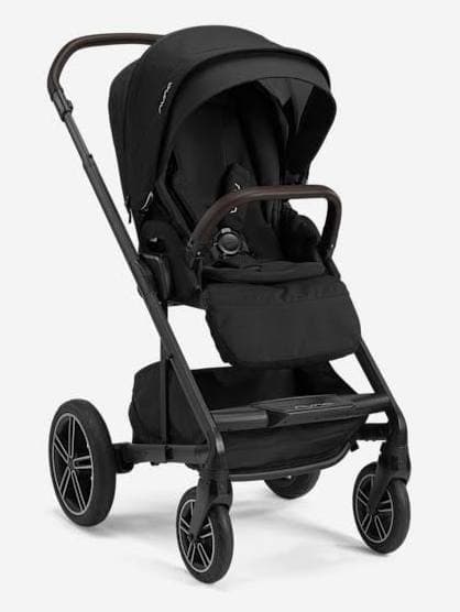 Nuna MIXX Next stroller in caviar color with parent tray on a city sidewalk
