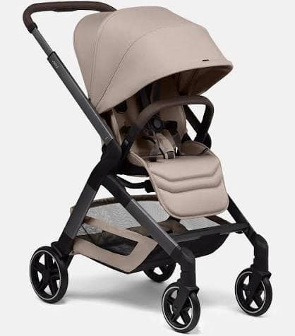 Joolz Hub 2 stroller in forest green with compact fold profile in an urban apartment setting