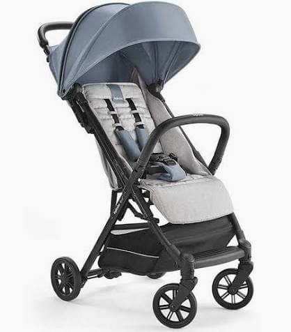 Inglesina Quid 2 stroller in night blue with fully reclined seat on a European city street