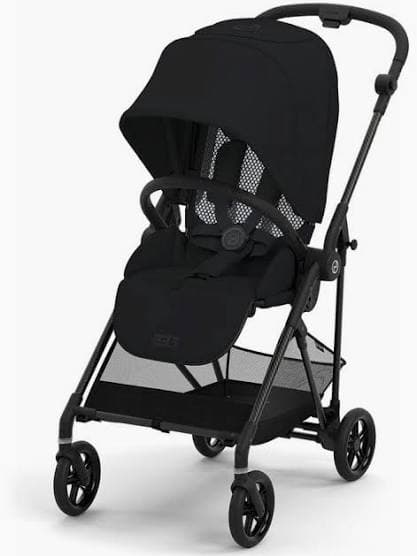 Cybex Melio Carbon stroller in lava grey with carbon fiber frame folded on a city sidewalk
