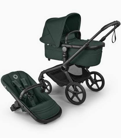 Bugaboo Fox 5 stroller in midnight black with bassinet on a tree-lined city street