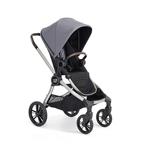 Baby Jogger City Sights stroller in Rich Black on a city sidewalk with reversible seat in parent-facing position