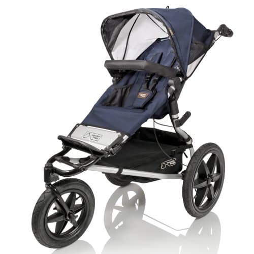 Mountain Buggy Terrain jogging stroller in black on a rugged trail with large air-filled tires