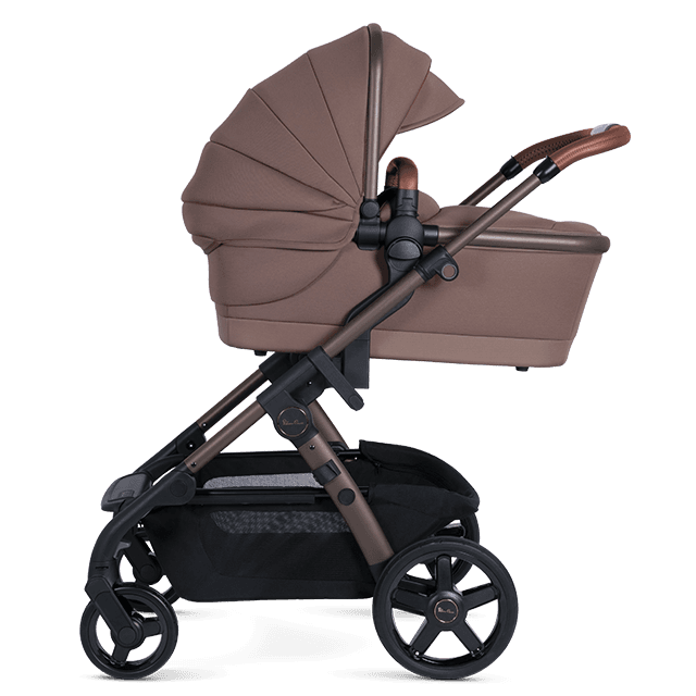 Silver Cross Wave convertible double stroller in Orbit color with bassinet and tandem seat on a city street