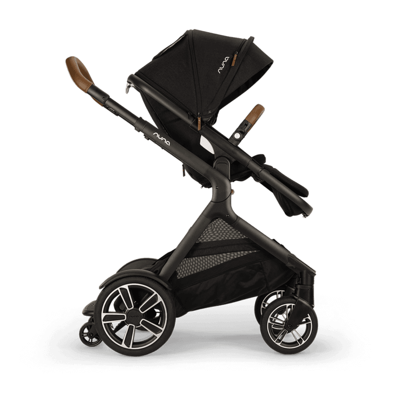 Nuna DEMI Next convertible double stroller in slate with tandem configuration on a city street
