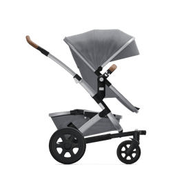 Joolz Day+ stroller in brilliant blue with bassinet on a park path in autumn